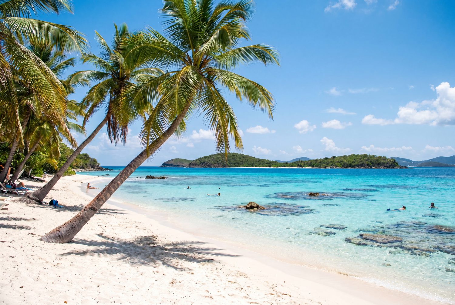 Palm trees, white sand and sapphire water at Sapphire Beach