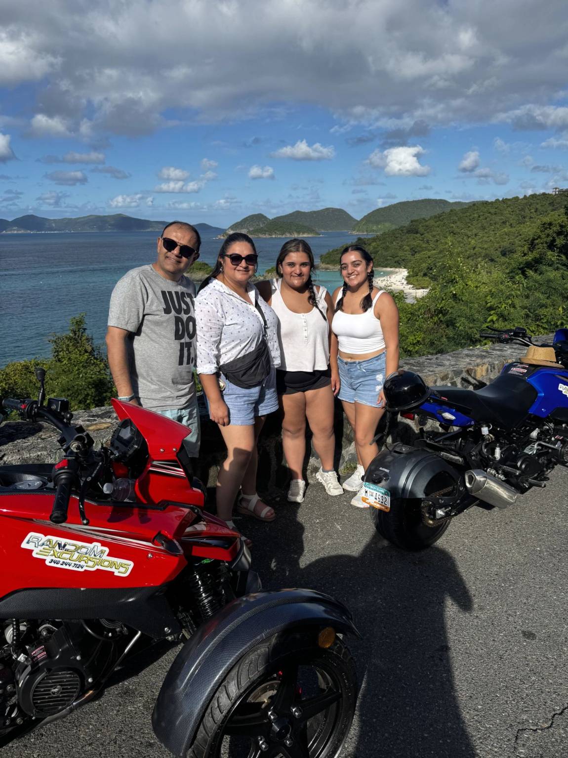 A family posing with their trikes at a St. John overlook