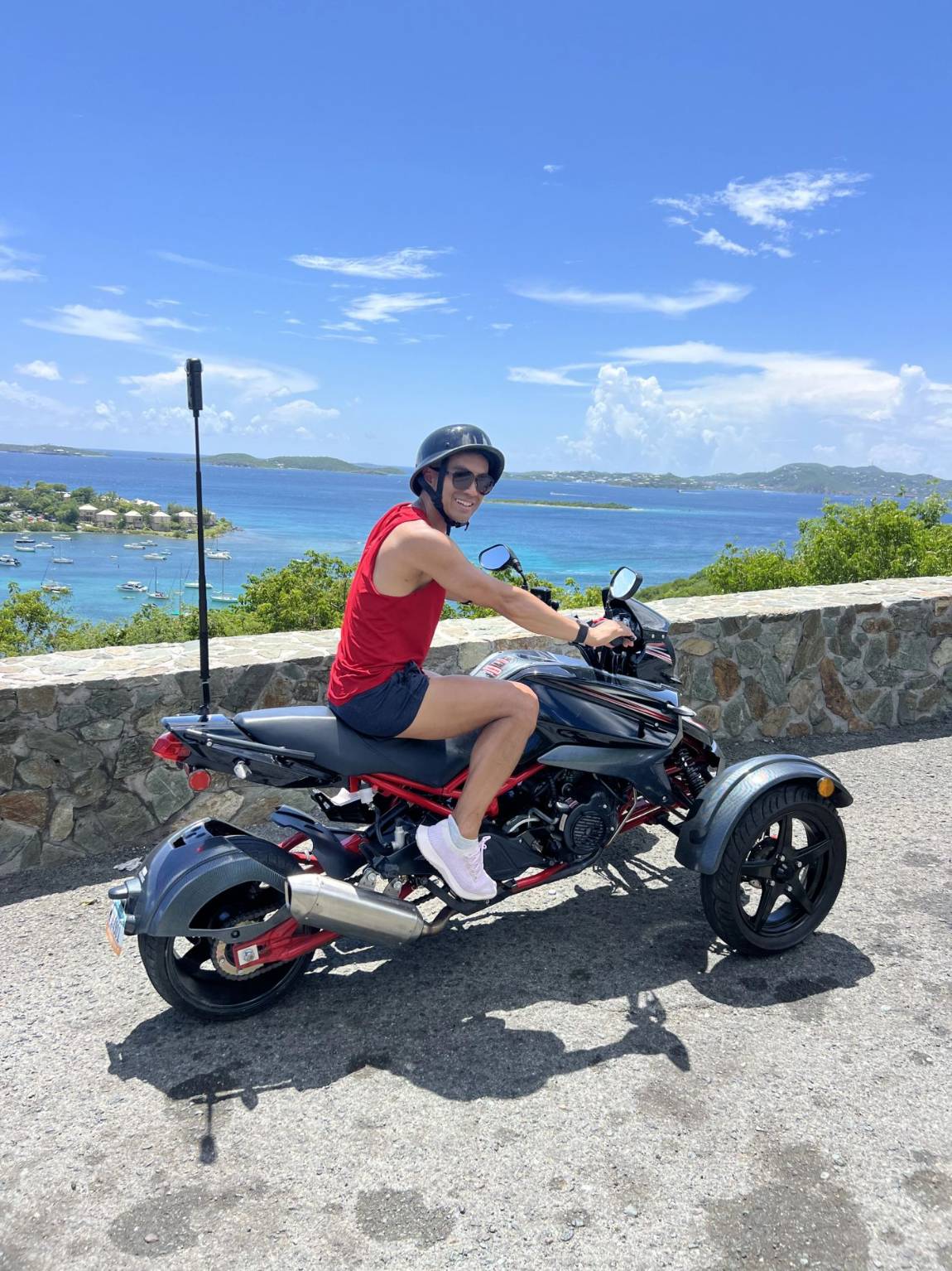 A rider on a three-wheel trike beside the sea on St. John
