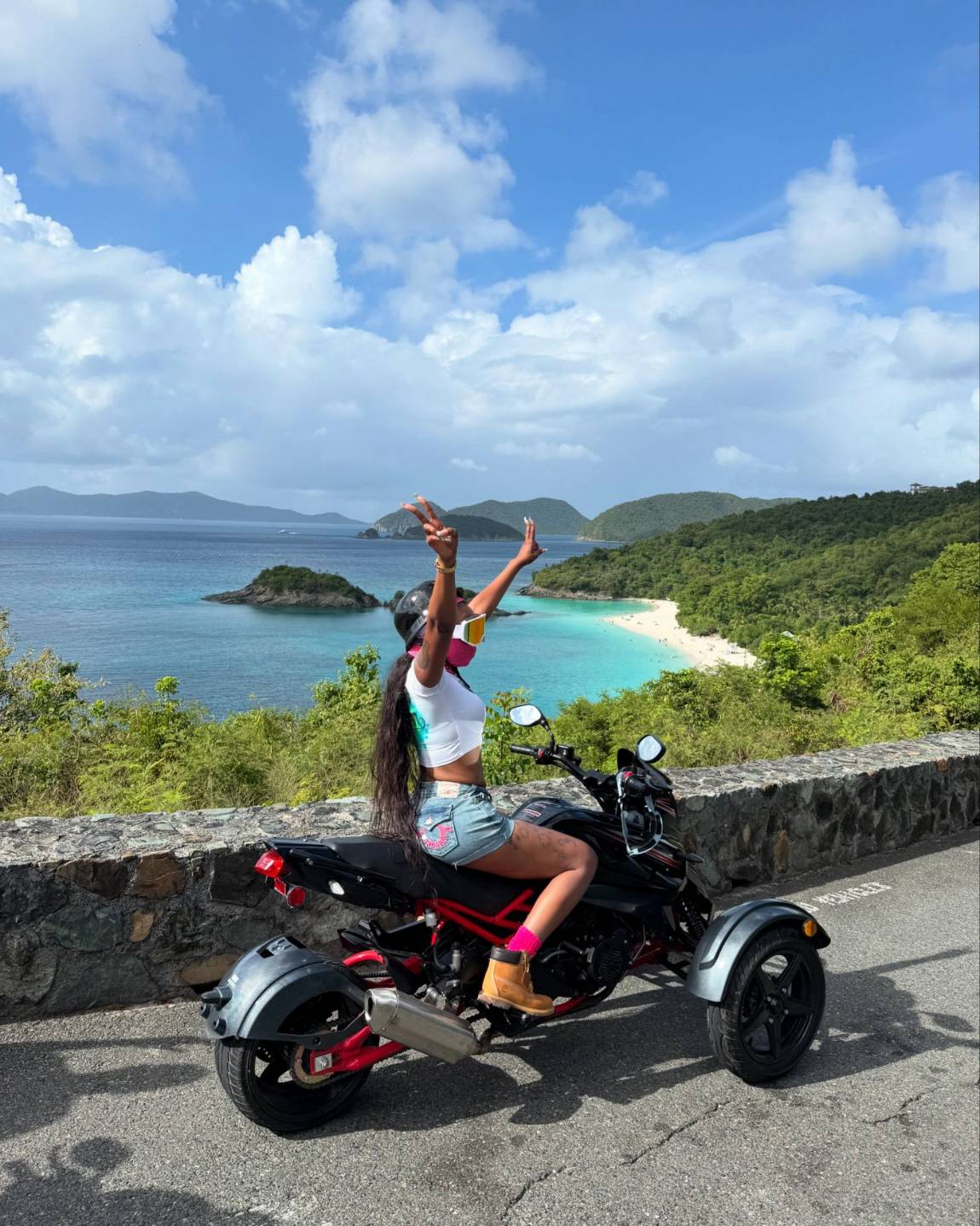 A rider posing on a trike above Trunk Bay